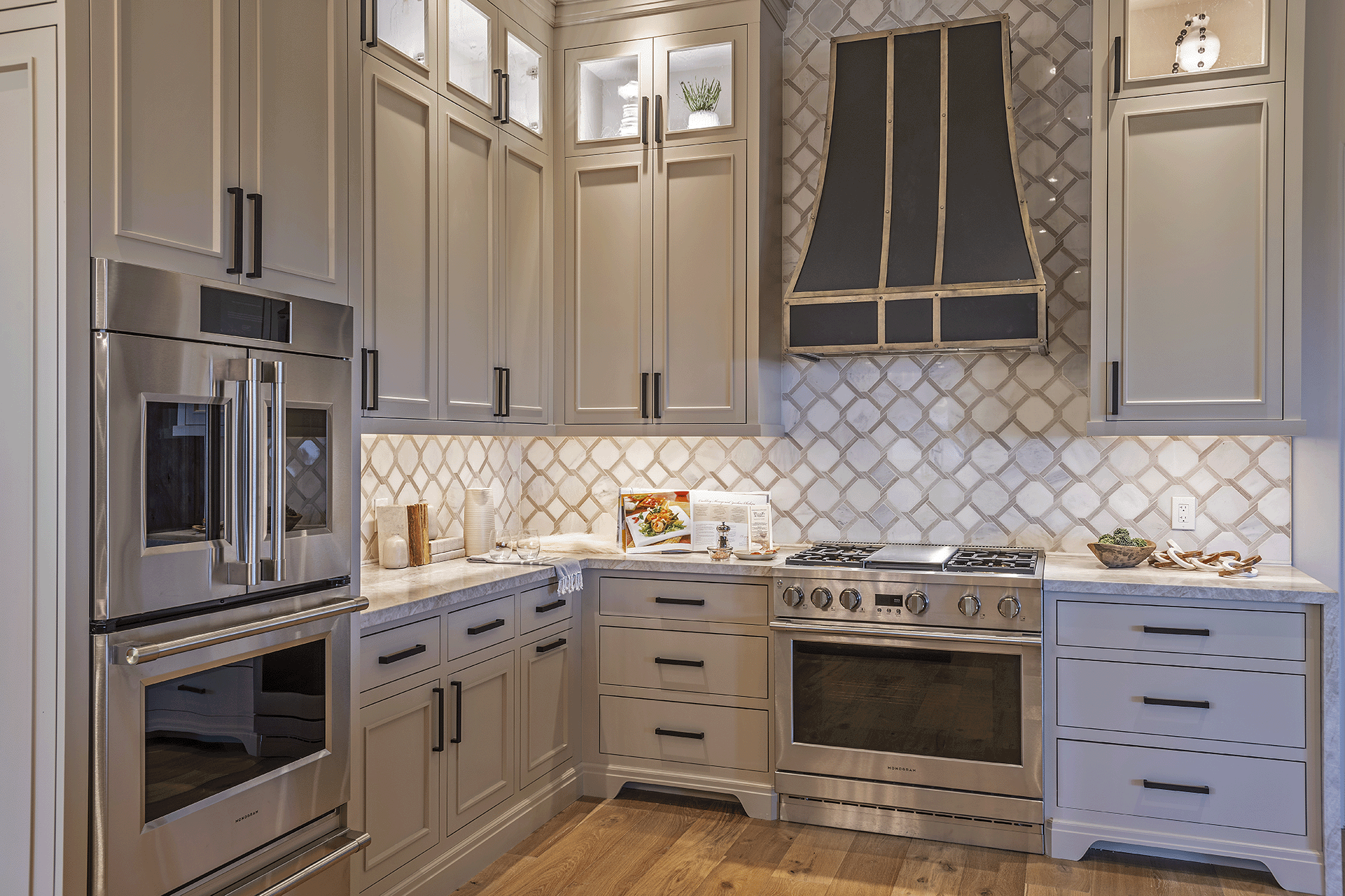 Neutral colored kitchen with beige and white, hardwood floors, stainless steel appliances.